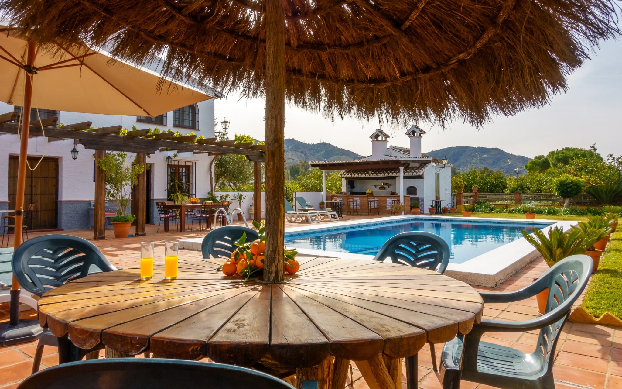 Idyllic breakfast spot under a thatched umbrella with mountain views.